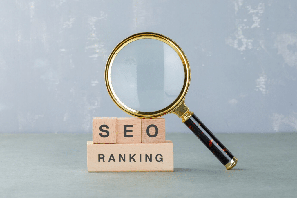 A magnifying glass resting on blocks that spell out 'SEO Ranking'
